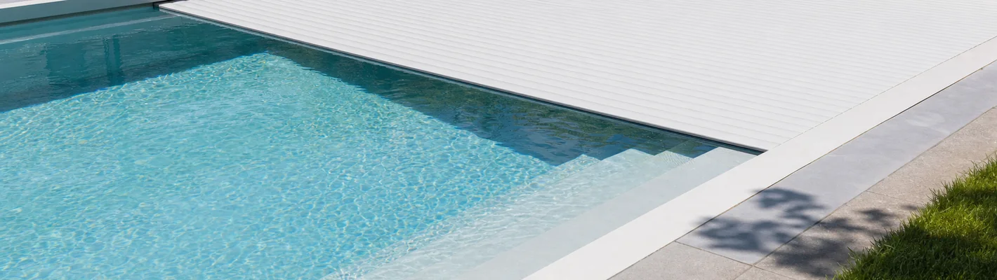 Unterflur-Rollladenabdeckung fährt über die Wasseroberfläche eines Pools