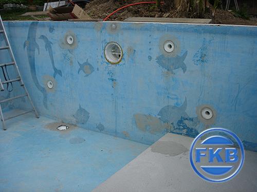 Altes hellblaues Poolbecken mit Delfin-Motiven und Einbauteilen vor der Sanierung