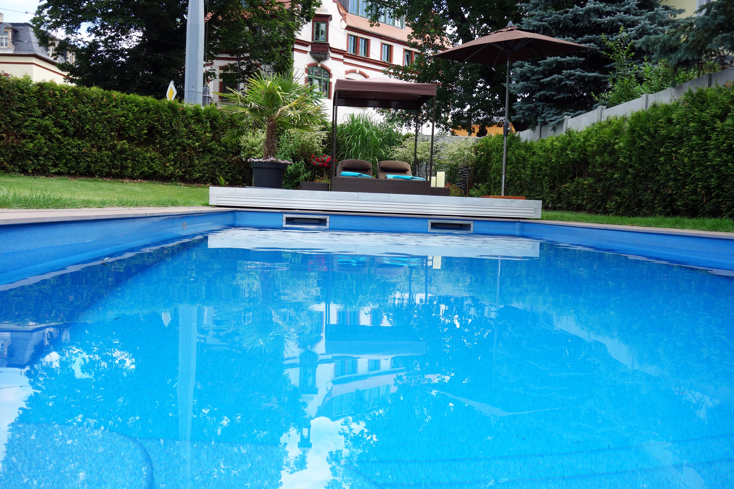 Compass Pool Schwimmbecken Java 101 mit blauer Folie und geöffneter Terrassenabdeckung